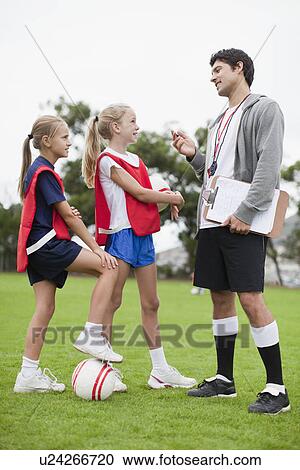 Coach talking to children on soccer team View Large Photo Image Stock Image - Coach talking to children on soccer team. Fotosearch