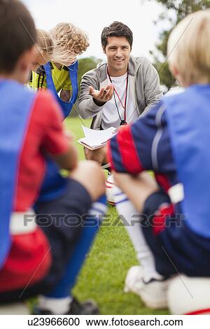 Coach talking to childrens soccer team View Large Photo Image Stock Image - Coach talking to childrens soccer team. Fotosearch