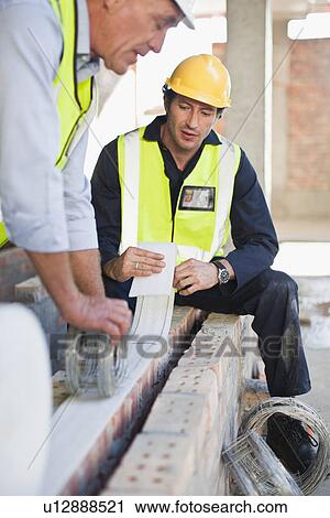 Stock Image - Construction worker on building site. Fotosearch