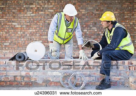 Stock Image - Construction worker on building site. Fotosearch
