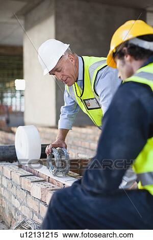 Stock Photography - Construction worker on building site. Fotosearch