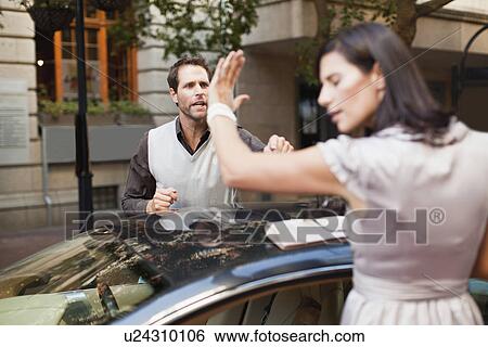 Couple arguing over sports car View Large Photo Image Stock Photograph - Couple arguing over sports car. Fotosearch