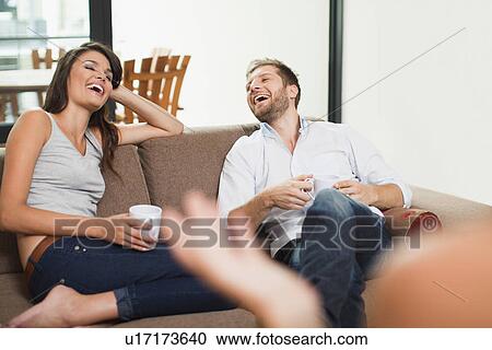 Couple having coffee together on sofa View Large Photo Image Stock Image - Couple having coffee together on sofa. Fotosearch