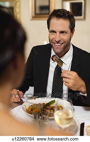 Couple having dinner in restaurant View Large Photo Image Picture - Couple having dinner in restaurant. Fotosearch