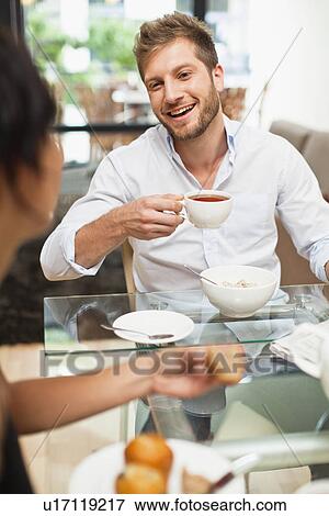 Stock Photo - Couple talking at breakfast. Fotosearch
