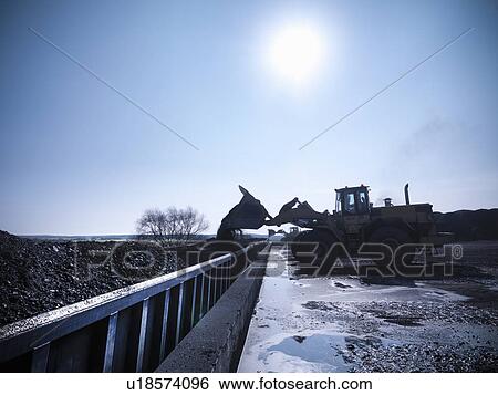 Digger pouring coal at mine View Large Photo Image Stock Photograph - Digger pouring coal at mine. Fotosearch