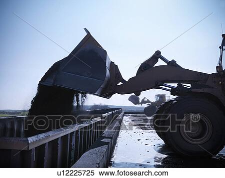Digger pouring coal at mine View Large Photo Image Stock Photography - Digger pouring coal at mine. Fotosearch