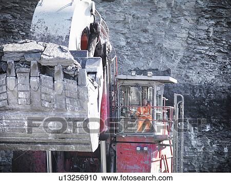 Digger scooping coal at mine View Large Photo Image Stock Image - Digger scooping coal at mine. Fotosearch