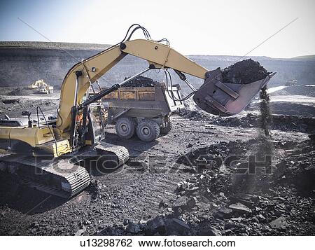 Digger scooping coal at mine View Large Photo Image Stock Image - Digger scooping coal at mine. Fotosearch