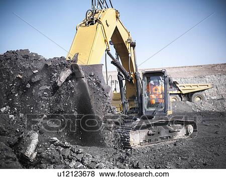 Digger scooping coal at mine View Large Photo Image Stock Photo - Digger scooping coal at mine. Fotosearch