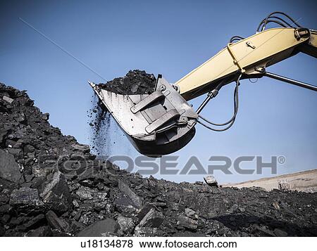 Digger scooping coal at mine View Large Photo Image Stock Photo - Digger scooping coal at mine. Fotosearch