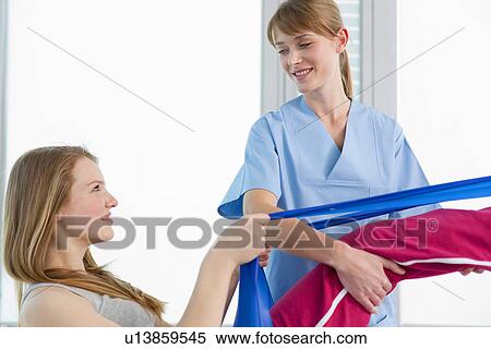 Stock Photography - Doctor examining girls legs in office. Fotosearch