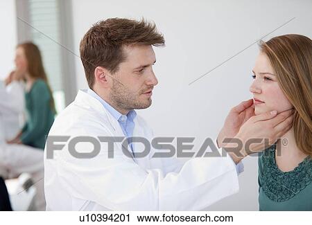 Doctor examining woman in office View Large Photo Image Stock Image - Doctor examining woman in office. Fotosearch
