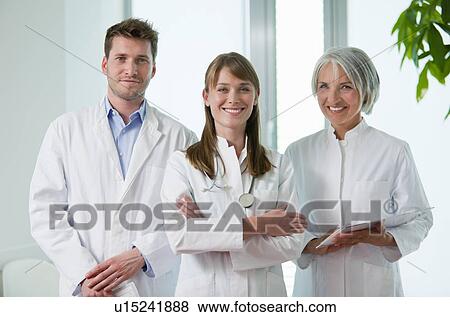 Doctors smiling together in hospital View Large Photo Image Stock Photo - Doctors smiling together in hospital. Fotosearch