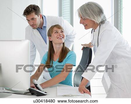 Doctors talking to receptionist View Large Photo Image Stock Image - Doctors talking to receptionist. Fotosearch
