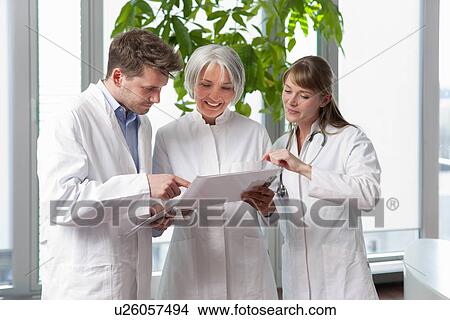 Doctors talking together in hospital View Large Photo Image Picture - Doctors talking together in hospital. Fotosearch