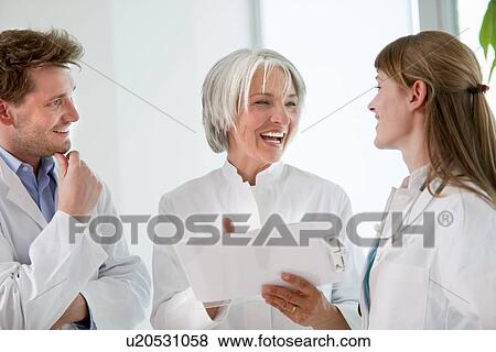 Doctors talking together in hospital View Large Photo Image Stock Photo - Doctors talking together in hospital. Fotosearch