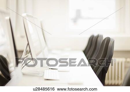 Stock Photograph - Empty computer desks in office. Fotosearch