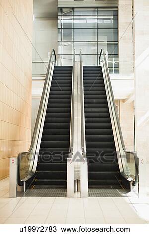 Empty escalators in lobby View Large Photo Image Stock Image - Empty escalators in lobby. Fotosearch