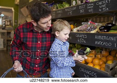 Father and son buying produce in store View Large Photo Image Stock Photo - Father and son buying produce in store. Fotosearch