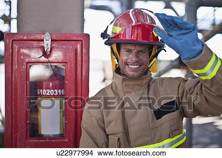 Picture - Firefighter smiling on site. Fotosearch