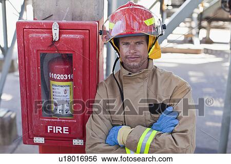 Stock Photograph - Firefighter smiling on site. Fotosearch