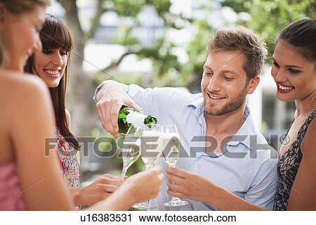 Friends drinking champagne together View Large Photo Image Stock Image - Friends drinking champagne together. Fotosearch