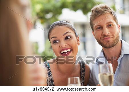 Stock Image - Friends drinking champagne together. Fotosearch