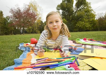 Girl drawing on picnic blanket View Large Photo Image Stock Image - Girl drawing on picnic blanket. Fotosearch