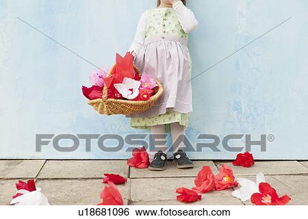 Girl holding basket of paper flowers View Large Photo Image Stock Photograph - Girl holding basket of paper flowers. Fotosearch