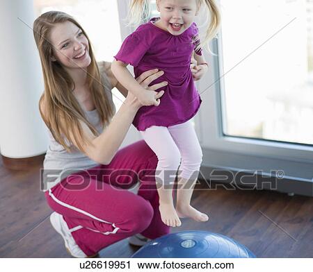Girls playing with exercise ball in gym View Large Photo Image Stock Image - Girls playing with exercise ball in gym. Fotosearch