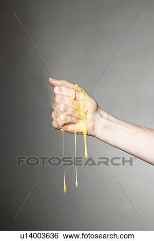 Hand crushing raw egg View Large Photo Image Stock Photograph - Hand crushing raw egg. Fotosearch