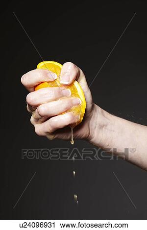 Hand squeezing orange View Large Photo Image Stock Image - Hand squeezing orange. Fotosearch