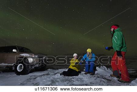 Hikers relaxing under aurora borealis View Large Photo Image Stock Photograph - Hikers relaxing under aurora borealis. Fotosearch