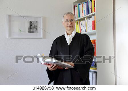 Lawyer reading text book in office View Large Photo Image Stock Photo - Lawyer reading text book in office. Fotosearch