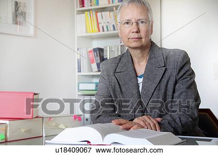 Lawyer reading text book in office View Large Photo Image Stock Photo - Lawyer reading text book in office. Fotosearch