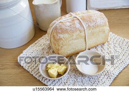 Picture - Loaf of bread with butter and salt. Fotosearch