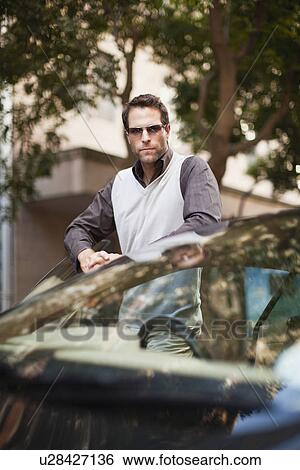 Man leaning on sports car View Large Photo Image Stock Photograph - Man leaning on sports car. Fotosearch