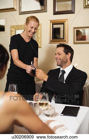 Man paying for dinner in restaurant View Large Photo Image Stock Photo - Man paying for dinner in restaurant. Fotosearch