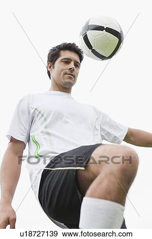 Man playing with soccer ball in field View Large Photo Image Stock Photo - Man playing with soccer ball in field. Fotosearch