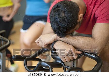 Man resting on spin machine in gym View Large Photo Image Stock Photo - Man resting on spin machine in gym. Fotosearch