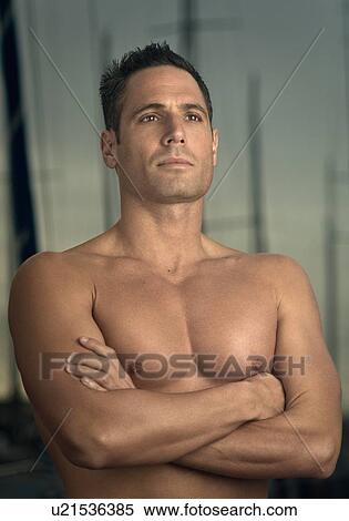 Man standing with arms crossed View Large Photo Image Stock Photography - Man standing with arms crossed. Fotosearch