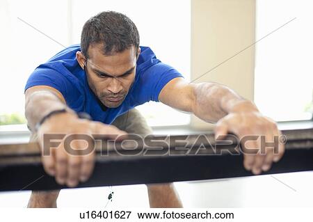 Man stretching in gym View Large Photo Image Stock Photo - Man stretching in gym. Fotosearch