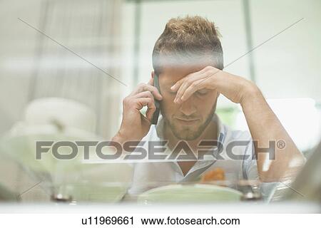 Man talking on cell phone at breakfast View Large Photo Image Stock Image - Man talking on cell phone at breakfast. Fotosearch