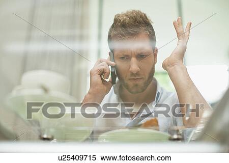 Man talking on cell phone at breakfast View Large Photo Image Stock Photography - Man talking on cell phone at breakfast. Fotosearch