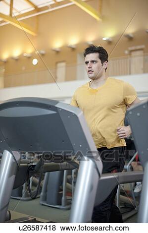 Man using treadmill in gym View Large Photo Image Stock Photo - Man using treadmill in gym. Fotosearch