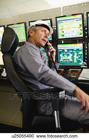 Man working in security control room View Large Photo Image Stock Image - Man working in security control room. Fotosearch