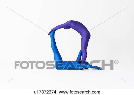 Picture - Men in bodysuits making the letter Q. Fotosearch