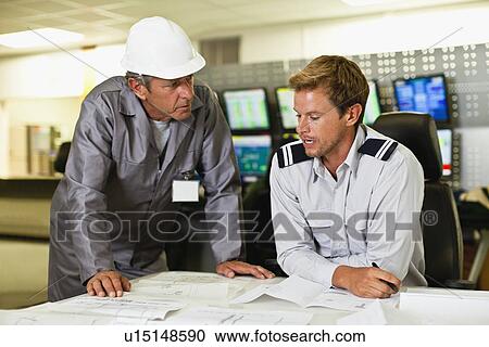 Stock Image - Men working in security control room. Fotosearch