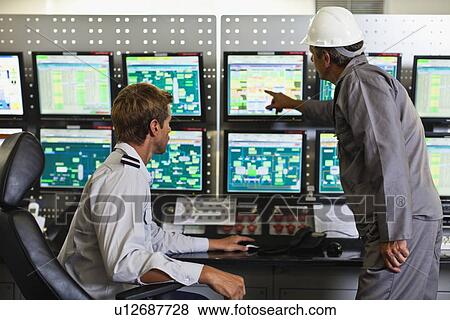 Stock Photo - Men working in security control room. Fotosearch